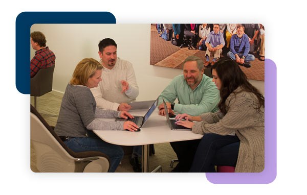 Coworkers gathered around table