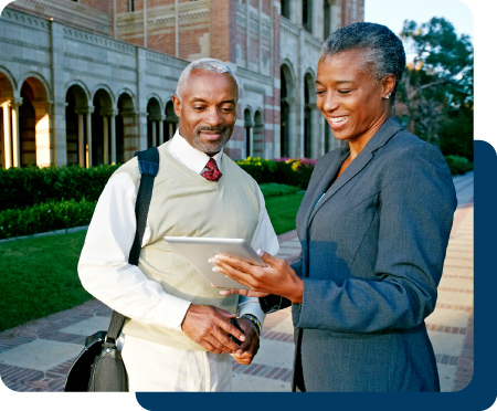 Two professionals meeting on a college campus.