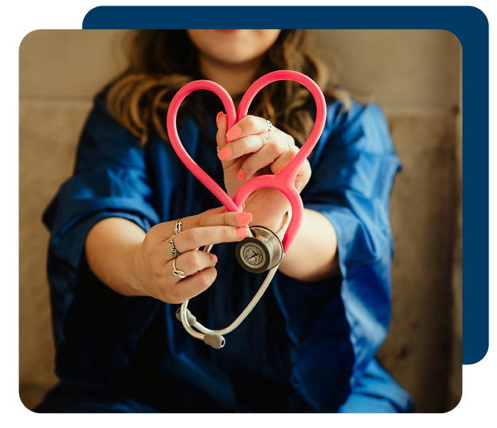 Person holding stethoscope in shape of heart