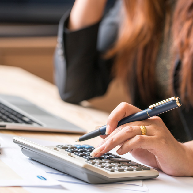 nonprofit employee using a calculator