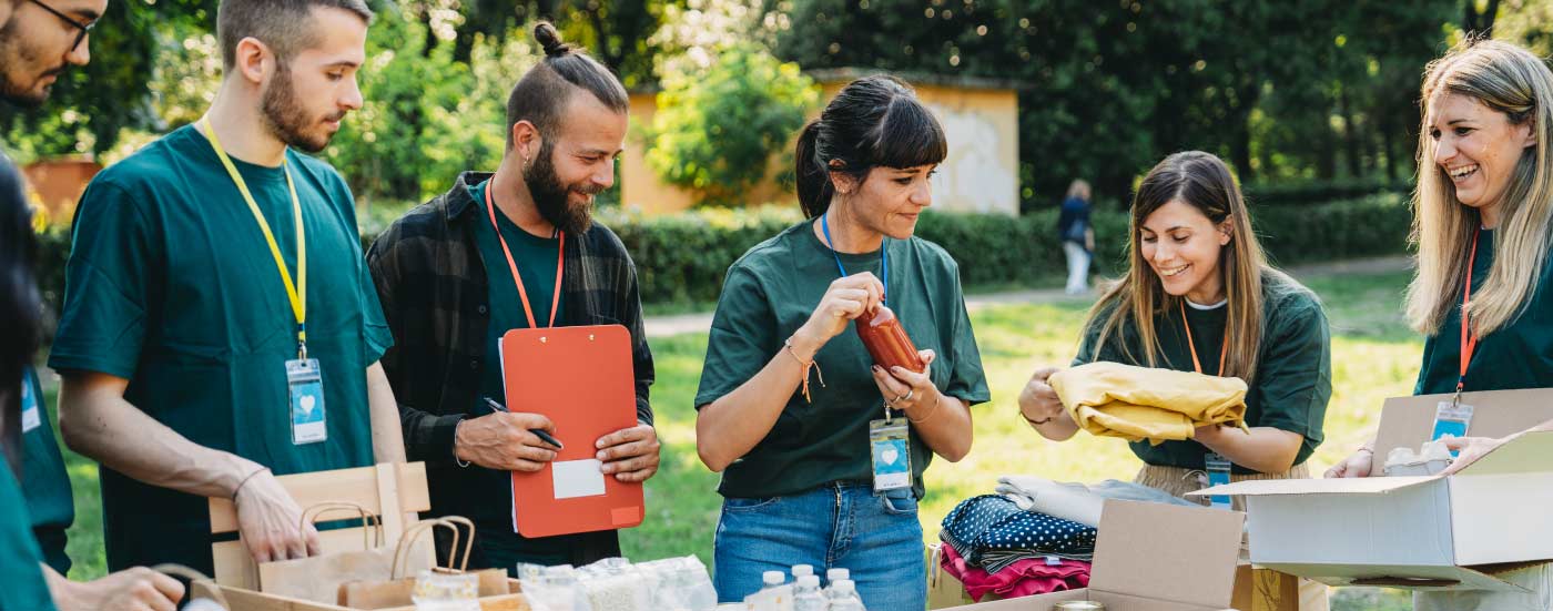 Nonprofit workers smiling and collecting goods