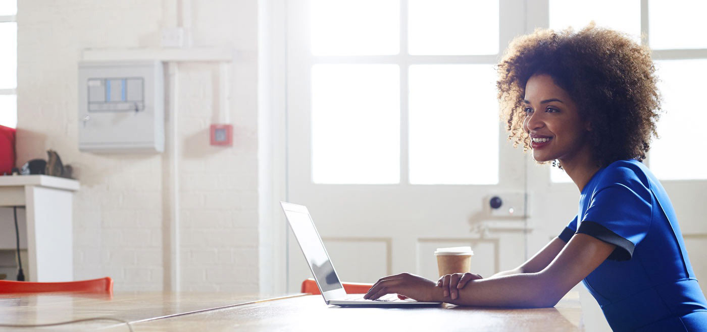 Lady working on computer smiling