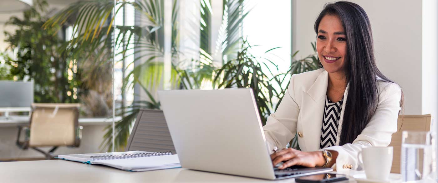 Person on computer working and smiling