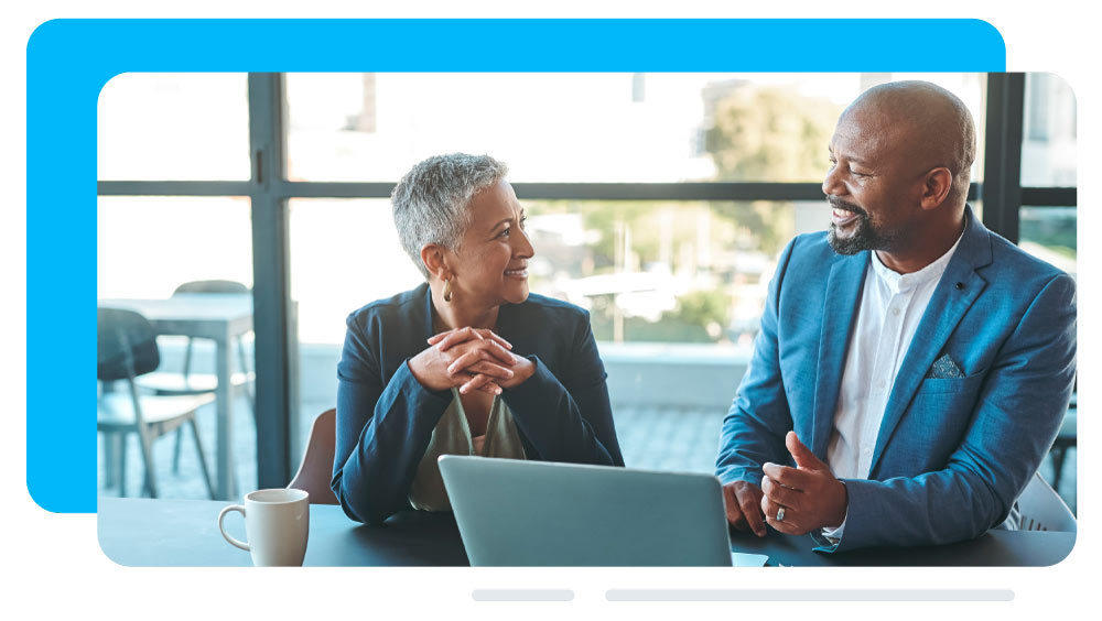 2 professionals in meeting with laptop