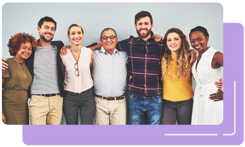 Group of people smiling and looking at the camera. 