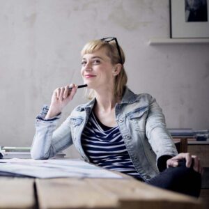 A woman thinking at her desk.