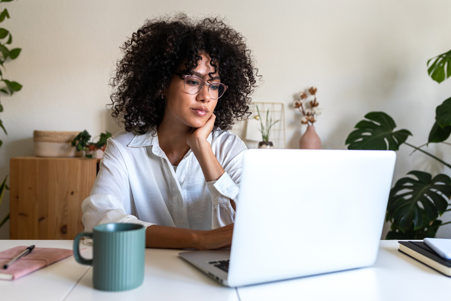 Woman reading fundraising communications on a laptop