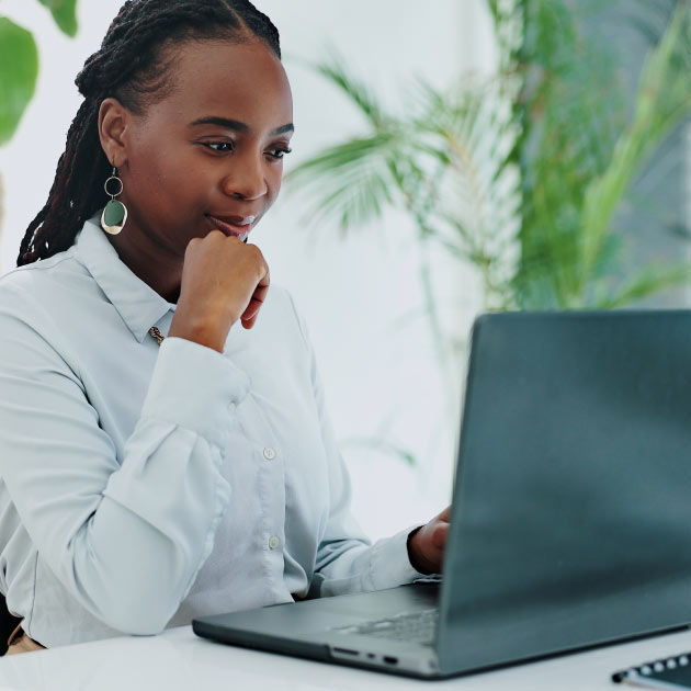 Business woman, thinking and laptop for online research in office and information on digital tech at desk. Black person, editor and inspiration on internet and creative writing on computer on blog