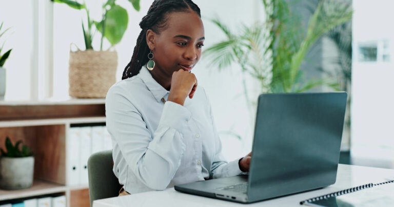 Business woman, thinking and laptop for online research in office and information on digital tech at desk. Black person, editor and inspiration on internet and creative writing on computer on blog