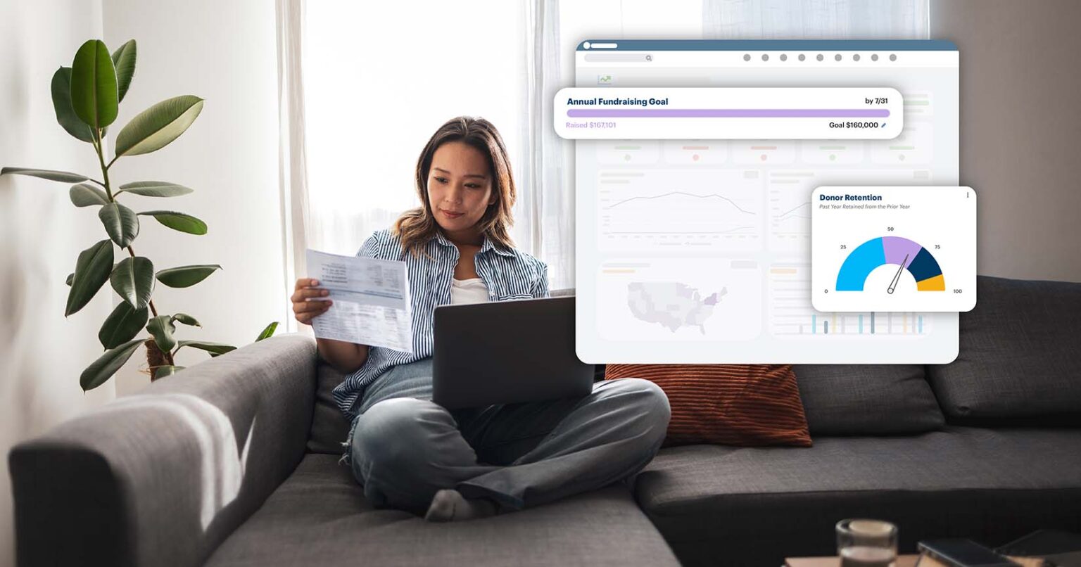 A woman looking a fundraising dashboards.