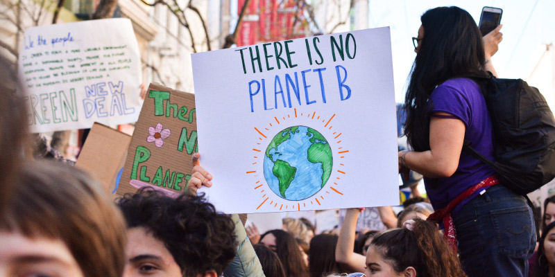person holding planet sign