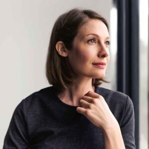 A woman pondering out the window.