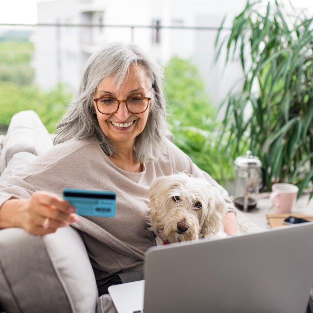Donor with dog on her computer updating her credit card information - featured image