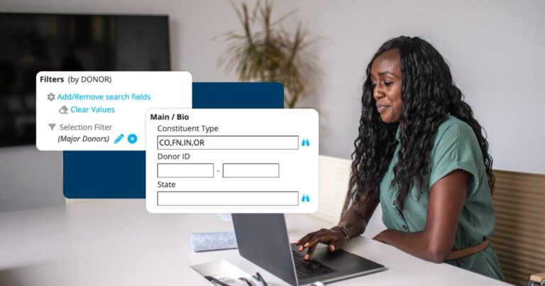 A focused mid-adult businesswoman engages with her laptop in a modern office setting, her professional attire and tools indicative of her expertise.