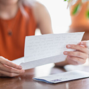 Detail view of young woman reading letter