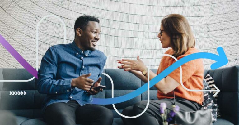 Businessman and woman using mobile phones while sitting on couch during conference