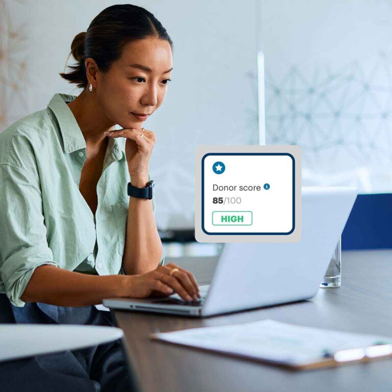 A woman using Donor Scores in DonorPerfect.