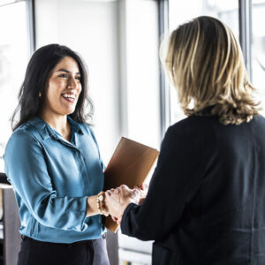 two nonprofit employees discussing next steps after getting a grant
