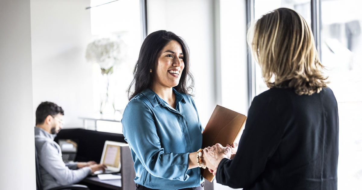 two nonprofit employees discussing next steps after getting a grant