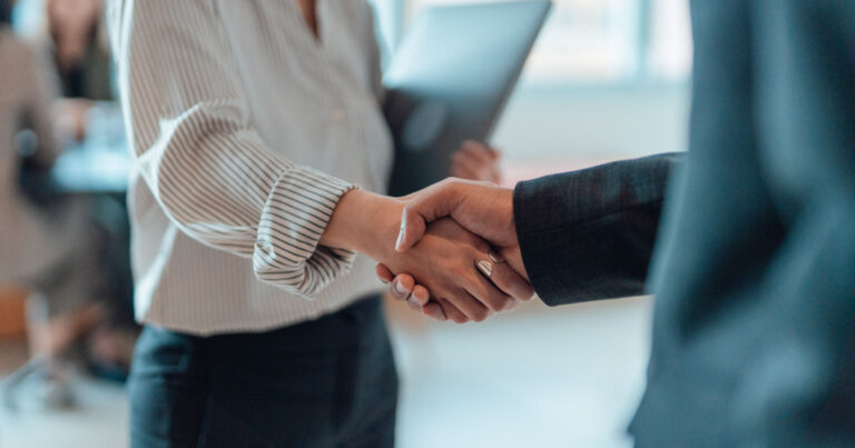 Cropped shot of business people standing in a modern office, shaking hands after having a successful meeting and reaching an agreement. Welcoming new hire. Celebrating success and achievement.