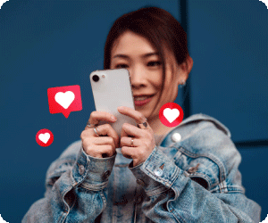 A girl on her phone with likes and hearts popping up.