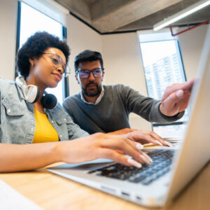 Image of two coworkers working on a computer