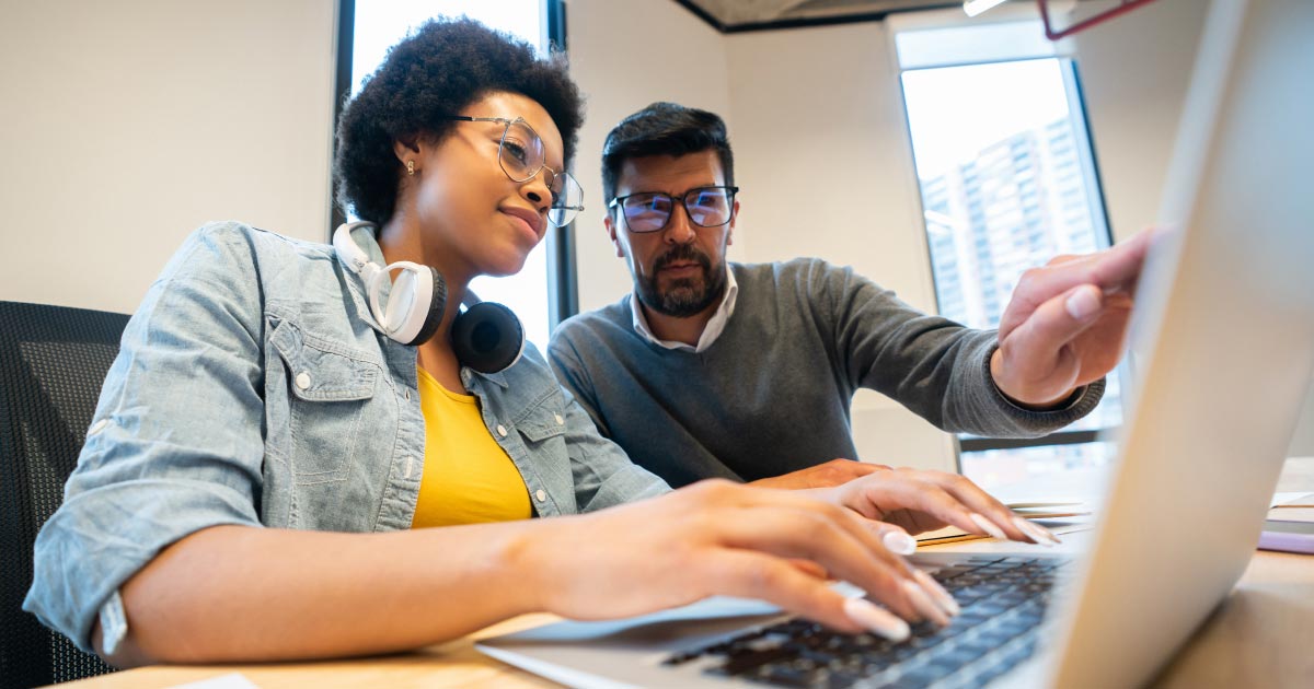 Image of two coworkers working on a computer