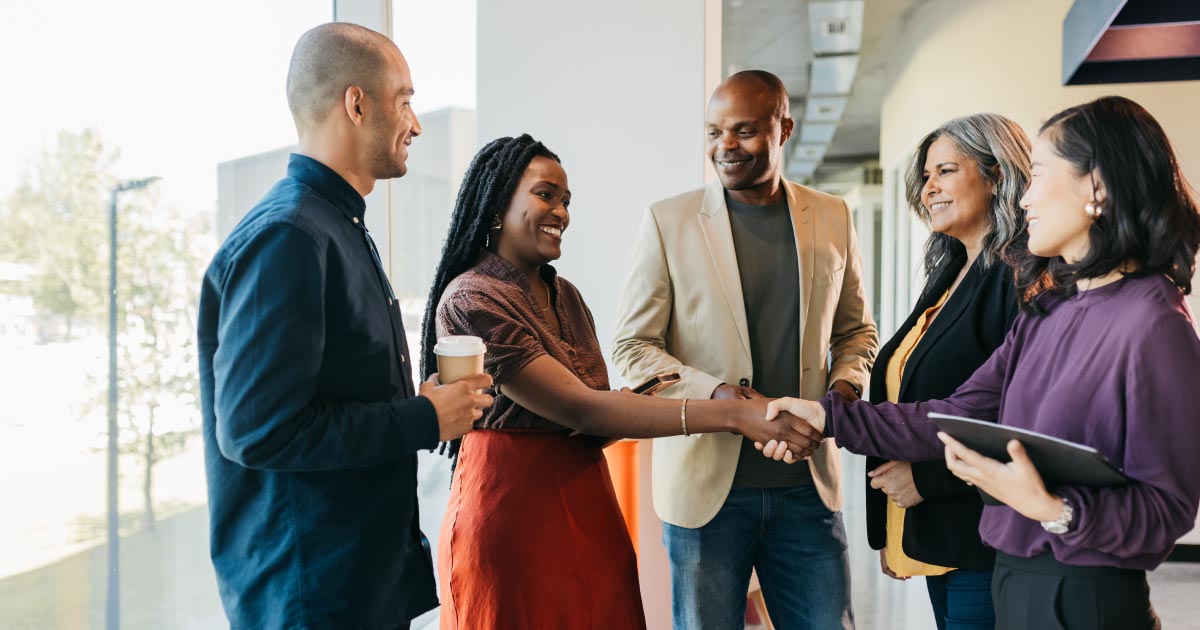 Multiracial business people discussing while meeting at the launch event. Businessmen and businesswomen talking at a conference event.