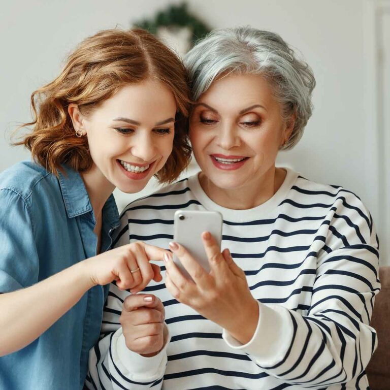 Two women using the DP mobile app.