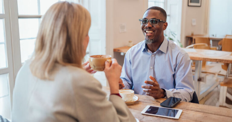A nonprofit professional making an ask to a major donor while drinking coffee at a coffee shop.