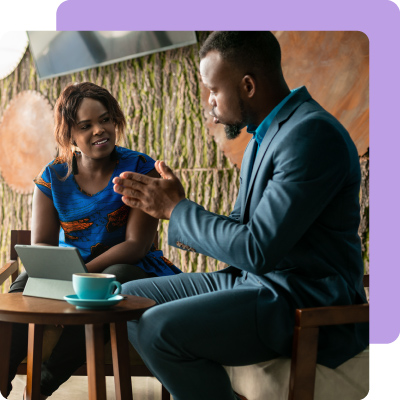 A major donor and fundraising professional talk while looking at a tablet. 