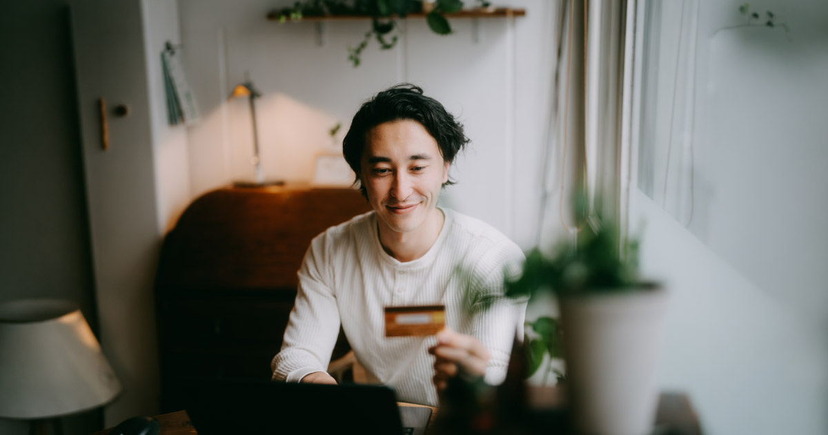 Man enjoying online donation with credit card at home