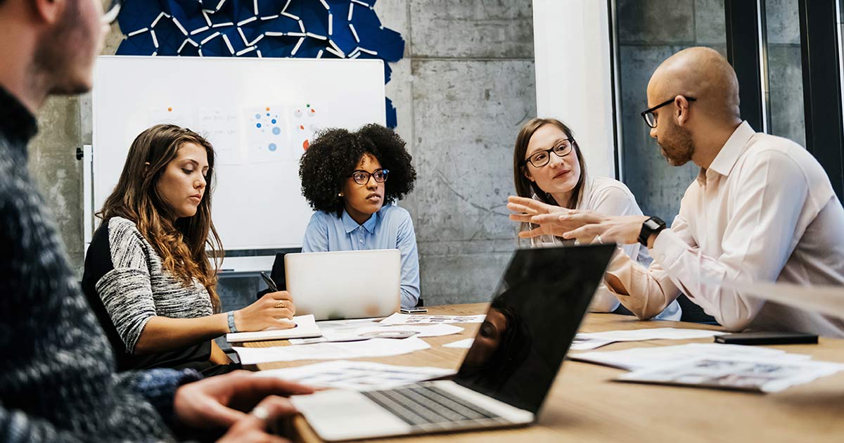 A group of people planning at a desk.