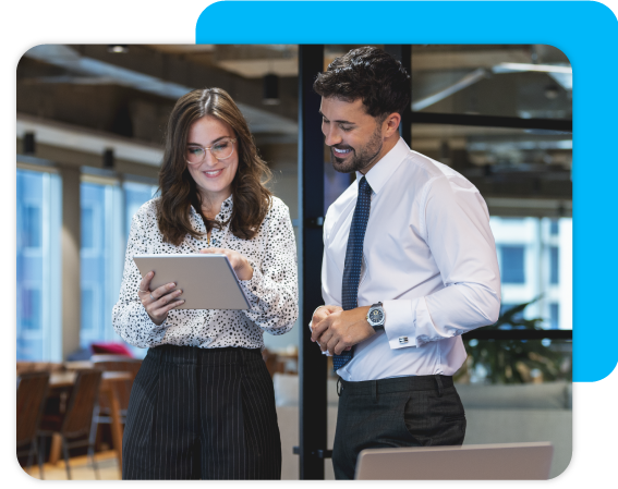 a man and a woman at work looking at a tablet to review data 