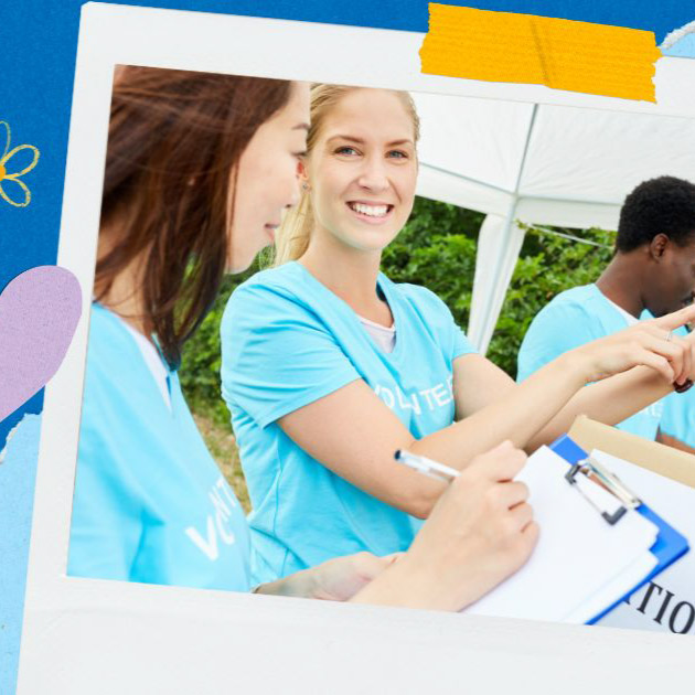 A group of smiling volunteers in blue shirts work together at an outdoor event, promoting Nonprofit Giving Days, with one person holding a clipboard and another displaying a tablet.