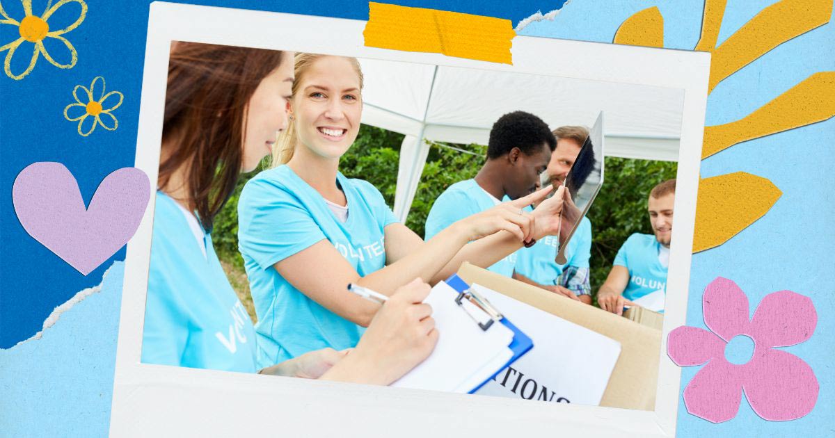 A group of smiling volunteers in blue shirts work together at an outdoor event, promoting Nonprofit Giving Days, with one person holding a clipboard and another displaying a tablet.