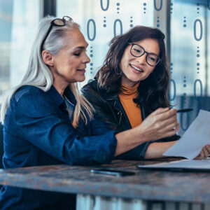 Two women discussing engagement models.