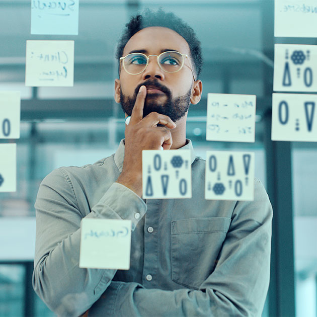 A man pondering notes.