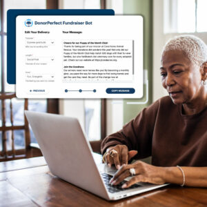 Senior woman using laptop at home using DonorPerfect's AI writer bot