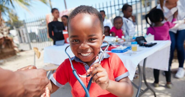Shot of a volunteer doctor giving checkups to underprivileged kids