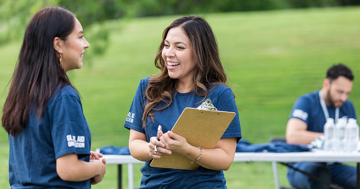 A woman tracking registrations at an event.