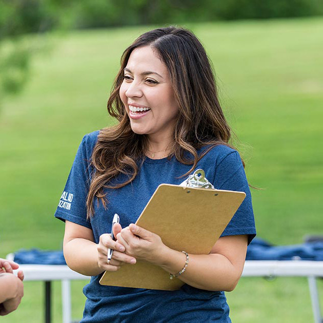 A woman tracking registrations at an event.