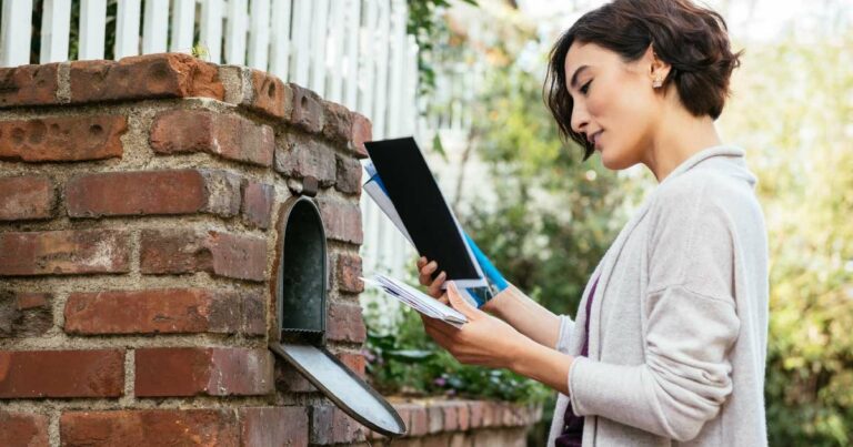 woman checking mail box