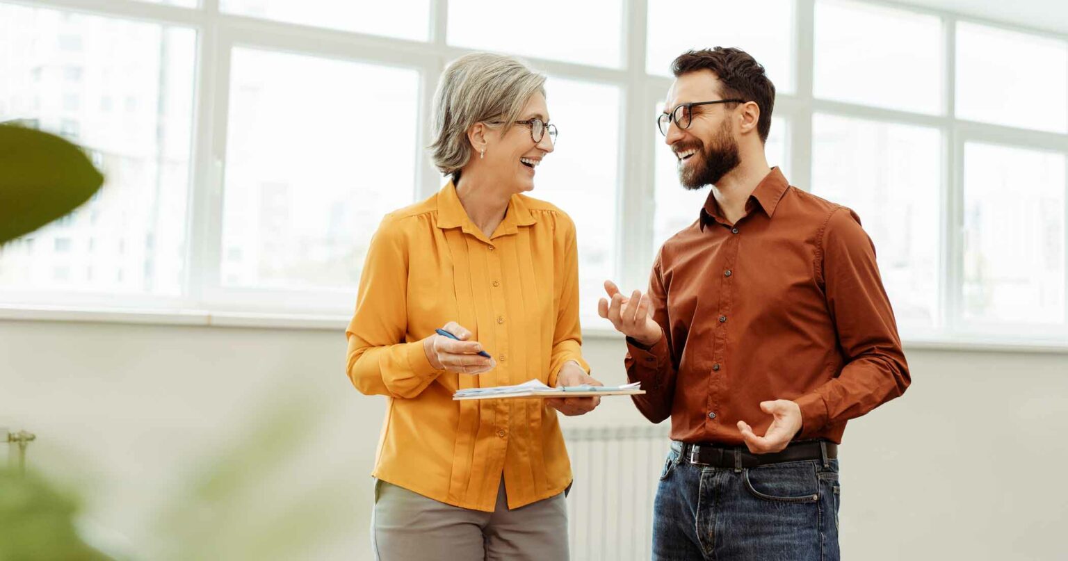 Two people talking about Grant Writing.