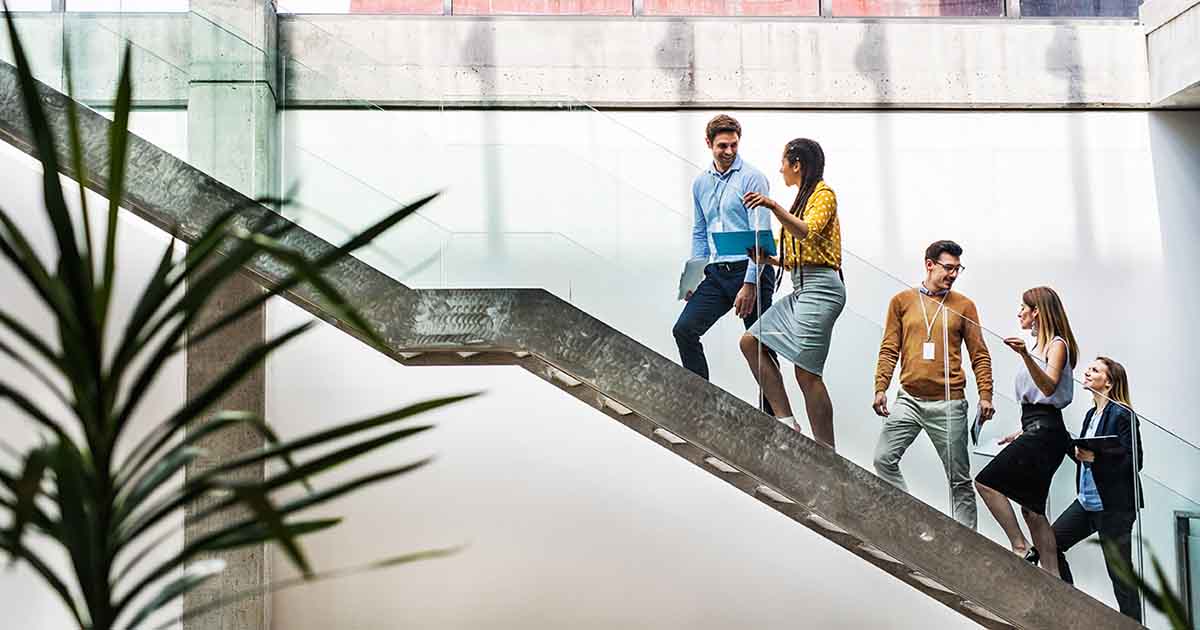 Office workers walking upstairs.