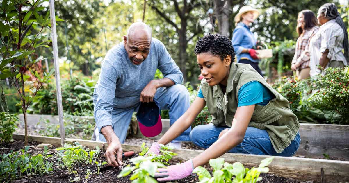 ather and adult daughter working in community garden