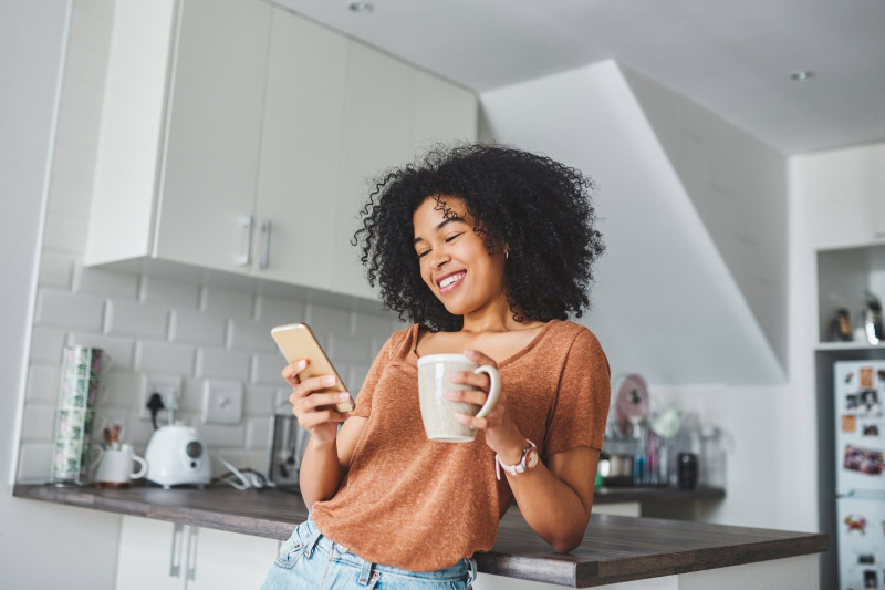 woman on phone with coffee