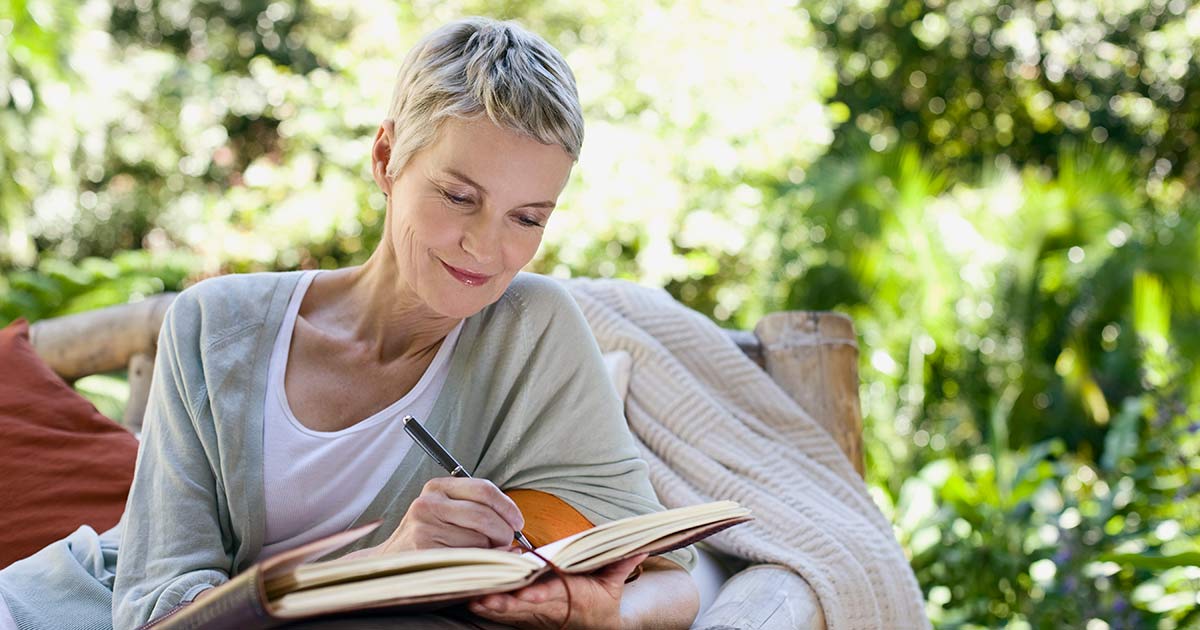 A woman writing Grants.