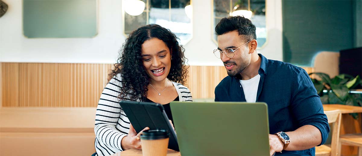 Two people working on a laptop.