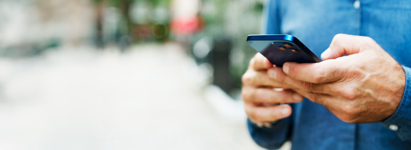 Close up of man using smart phone
